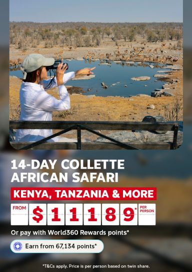 Woman watching wildlife gather at a waterhole for a 14-day Collette African safari through Kenya Tanzania and more from $1189 per person