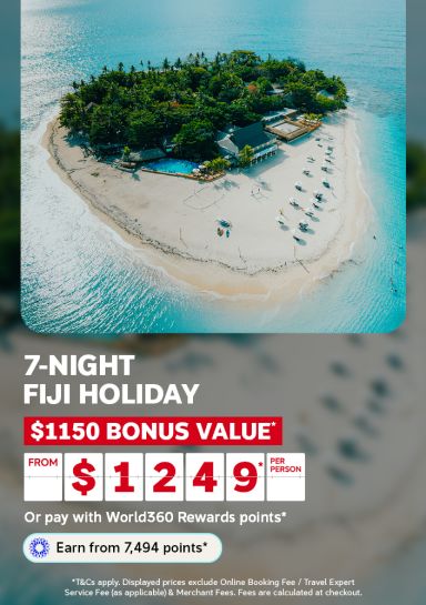 Aerial view of a lush tropical island resort surrounded by turquoise water for a 7-night Fiji holiday offering 1150 bonus value from 1249 per person