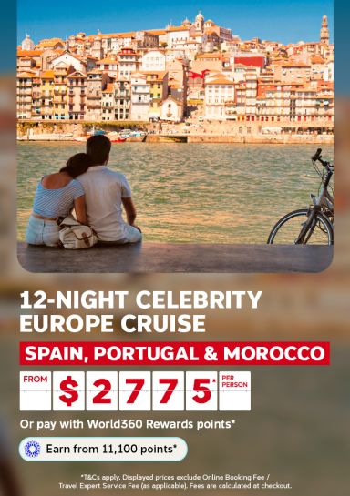 Couple sitting by the river admiring colourful Porto rooftops for a 12-night Celebrity Europe cruise visiting Spain Portugal and Morocco from 2775