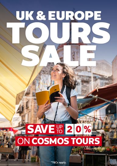 Woman reading a guidebook at a sunlit European market for the UK and Europe tours sale saving up to 20% on Cosmos tours