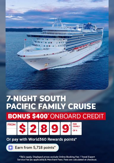 Cruise ship sailing at dusk on calm ocean for a 7 night South Pacific family cruise with 400 dollars bonus credit from 2899 per family of 4