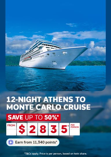 White cruise ship Regatta sailing calm blue waters past lush green islands for a 12-night Athens to Monte Carlo cruise saving up to 50% from $2835