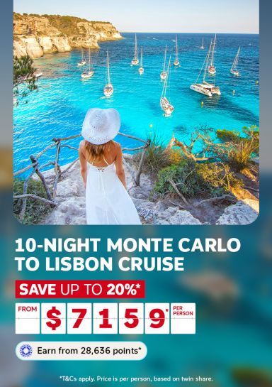 Woman in a white dress overlooking a turquoise bay with sailboats for a 10-night Monte Carlo to Lisbon cruise saving up to 20% from 7159 per person