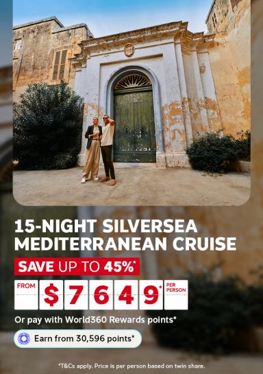 Couple admiring a weathered Maltese archway and doorway for a 15-night Silversea Mediterranean cruise saving up to 45% from $7649 per person