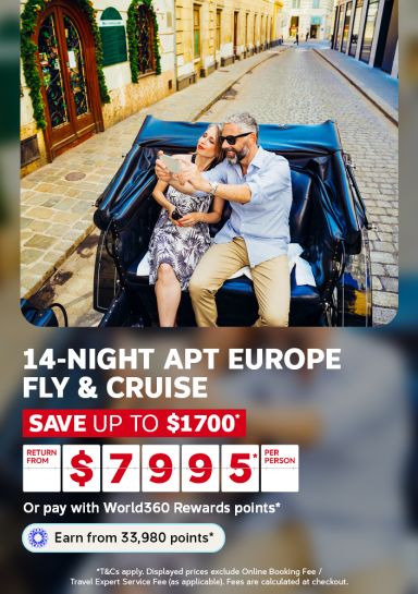 Couple taking a selfie in a horse drawn carriage on a cobblestone street for a 14-night APT Europe fly and cruise saving up to 1700 from 7995