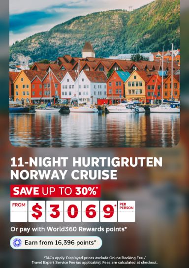 Colourful waterfront buildings and mountains reflected in still water for an 11-night Hurtigruten Norway cruise saving up to 30% from $3069