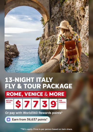 Woman in a sun hat admiring a stone archway over turquoise water on the Amalfi Coast for a 13-night Italy fly and tour package from $7739 per person