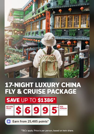 Traveller exploring a lantern-draped heritage building in China for a 17-night luxury fly and cruise package saving up to $1386 from $6995 per person
