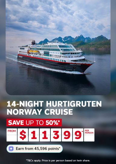 Cruise ship sailing through Norwegian fjords surrounded by mountains for a 14-night Hurtigruten cruise saving up to 50% from $1199 per person