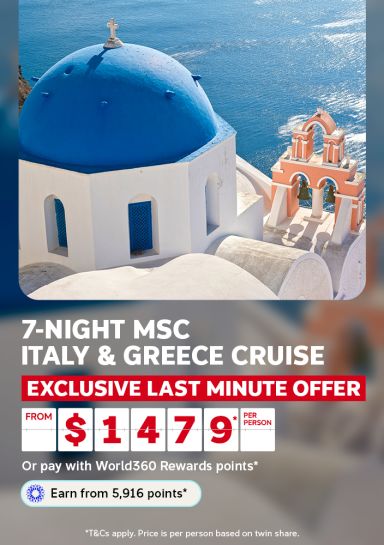 Blue domed church overlooking the Santorini coastline for a 7-night MSC Italy and Greece cruise exclusive last minute offer from $1479 per person