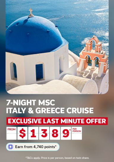 Blue domed church overlooking the sea in Santorini for a 7-night MSC Italy and Greece cruise last minute offer from $1389 per person
