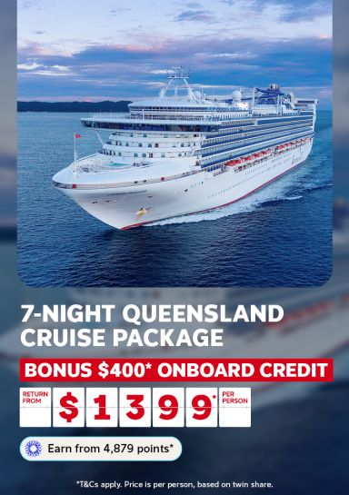 Cruise ship sailing at dusk off a lush coastline for a 7-night Queensland cruise package with bonus $400 onboard credit from $1399 per person return