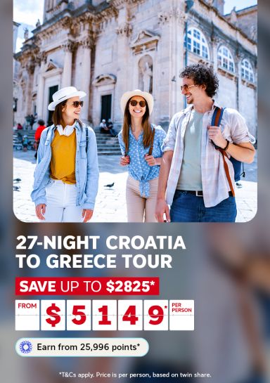 Friends walking past a grand cathedral in Dubrovnik for a 27-night Croatia to Greece tour saving up to 2825 dollars from 5149 per person