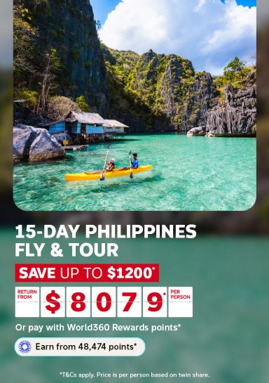 Couple kayaking through a turquoise lagoon beneath limestone cliffs for a 15-day Philippines fly and tour saving up to $1200 from $807 per person