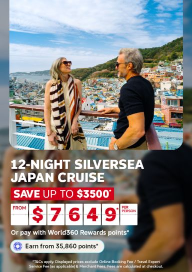 Couple admiring a colourful coastal hillside village for a 12-night Silversea Japan cruise saving up to 3500 from 7649 per person
