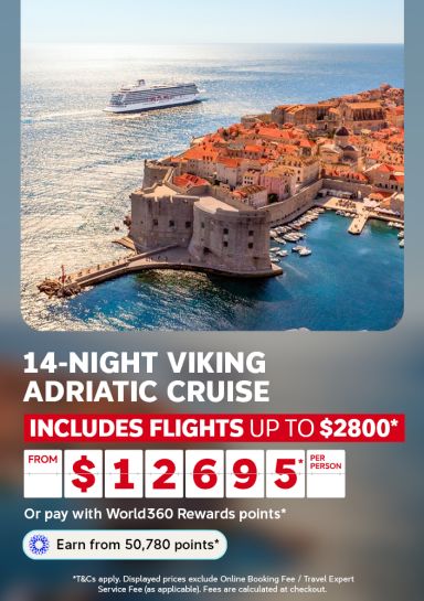 Cruise ship sailing past the walled old town of Dubrovnik on sparkling blue water for a 14 night Viking Adriatic cruise from $12695 per person including flights up to $2800