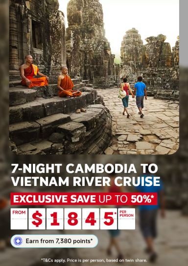 Buddhist monks meditating at Angkor Thom temple for a 7 night Cambodia to Vietnam river cruise saving up to 50% from $1845 per person