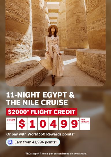 Woman strolling through towering Karnak Temple columns for an 11-night Egypt and Nile cruise with $2000 flight credit from $1049 per person
