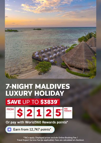 Golden sunset over turquoise Maldives lagoon with beachfront dining pavilion and thatched bungalow for a 7-night luxury holiday from $2125