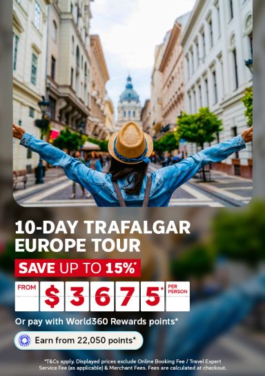 Woman with arms outstretched on a European street facing a domed church for a 10 day Trafalgar Europe tour saving 15% from $3675 per person