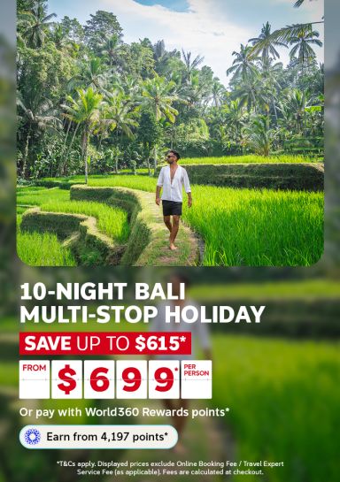 Man walking through Bali’s lush rice paddies and palm trees for a 10-night multi-stop holiday from $6999 per person, saving up to $615