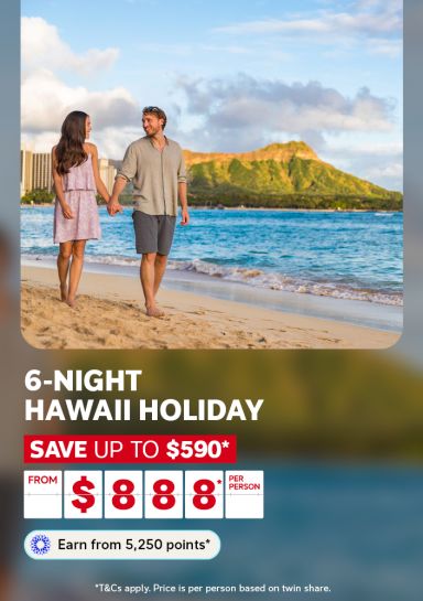 Couple walking hand in hand along Waikiki beach near Diamond Head for a 6-night Hawaii holiday saving up to 590 dollars from 888 per person