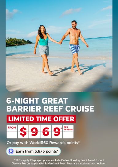 Couple walking hand in hand along a tropical beach for a 6-night Great Barrier Reef cruise limited time offer from 969 per person