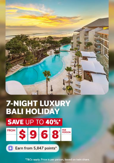 Sweeping resort pool overlooking Seminyak Beach at golden sunset for a 7-night luxury Bali holiday saving up to 40% from $968 per person