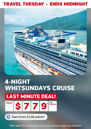 Cruise ship with a waterslide anchored near the Whitsundays for a Travel Tuesday 4-night cruise last minute deal from 779 dollars per person