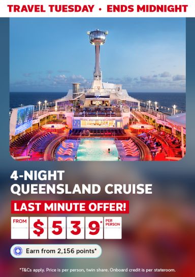 Cruise ship pool deck glowing at dusk for a Travel Tuesday 4-night Queensland cruise last minute offer from $539 per person