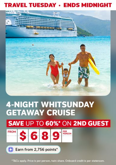 Family of three playing in the surf with a cruise ship in the background featuring a 4-night Whitsunday cruise from $689* per person