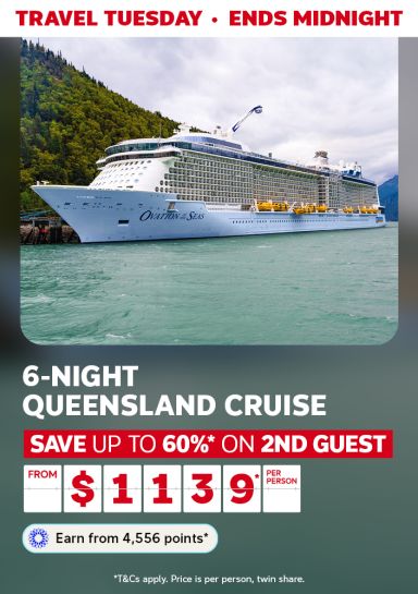 Royal Caribbean cruise ship sailing past a lush forest, featuring a 6-night Queensland cruise from $1,139