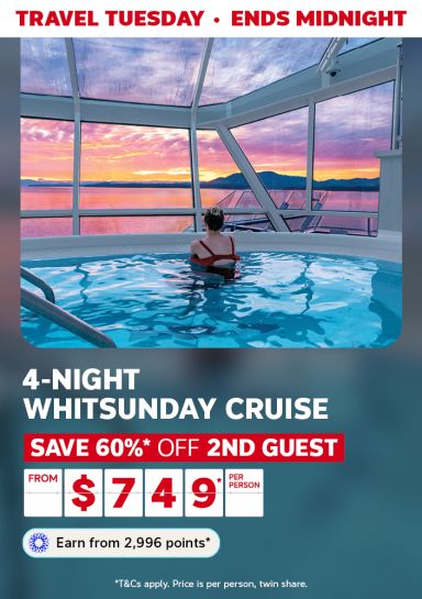Woman in a pool on a cruise ship looking at the sunset featuring a 4-night Whitsunday cruise from $749
