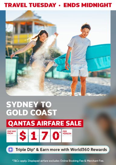 Two young adults kicking sand and laughing featuring one way flights to the Gold Coast from $170 with Qantas