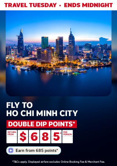 Aerial shot of Ho Chi Minh city at night featuring flights return from $685