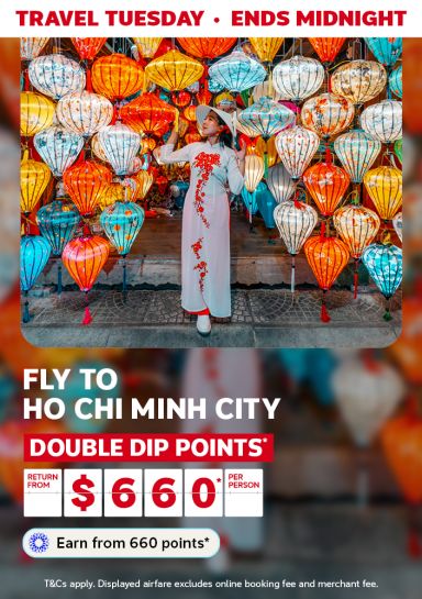 Travel Tuesday - ends midnight | Fly to Ho Chi Minh City - double dip points* | Return from $660* per person | Earn from 660 points* | *T&Cs apply. Displayed airfares excludes online booking fee and merchant fee. | Woman surrounded by lanterns