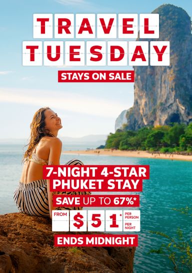 Travel Tuesday - stays on sale | 7-night 4-star Phuket stay | from 451* per person, per night - ends midnight | Woman smiling sitting on a rock, looking out at the ocean