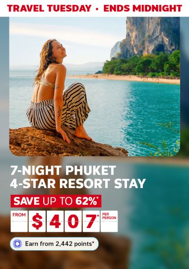 Travel Tuesday - ends midnight | 7-night Phuket 4-star resort stay | Save up to 62%* - from $407* per person | Earn from 2,442 points* | Woman relaxing on a rock looking out at the ocean