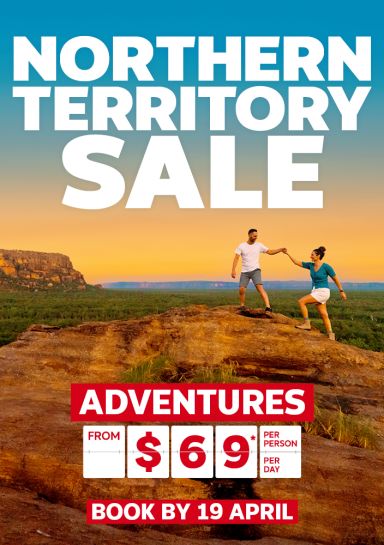 Northern Territory Sale - adventures from $69* per person, per day | book by 19 April | couple climbing a rock overlooking the Australian Outback
