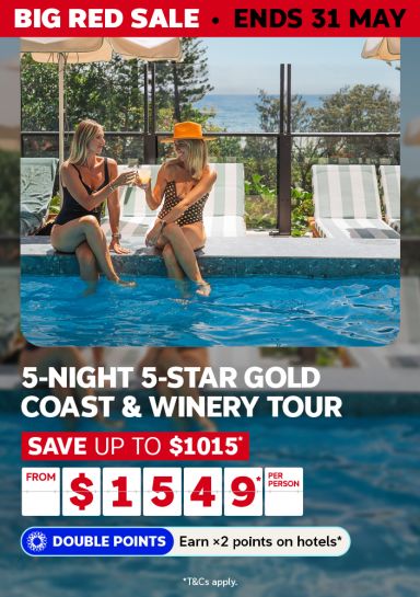 Two women clinking cocktails poolside for a Big Red Sale 5-night 5-star Gold Coast and winery tour saving up to $1015 from $1549 per person