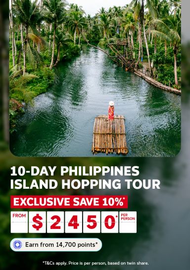 10-day Philippines island hopping tour | exclusive save 10%* from $2,450* per person | Earn from 14,700 points* | *T&Cs apply. Price is per person, based on twin share | Wide shot of a woman on a bamboo raft in a palm tree jungle