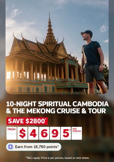 10-night spiritual Cambodia & the Mekong cruise & tour | save $2,800* from $4,695* per person | Earn from 18,780 points* | *T&CS apply. Price is per person, based on twin share | man walking past a temple in Cambodia