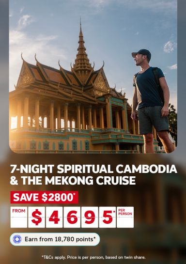 7-night spiritual Cambodia & the Mekong cruise | save $2800* from $4,695* per person | Earn from 18,780 points* | *T&Cs apply. Price is per person, based on twin share. | Man walking past a temple at sunrise