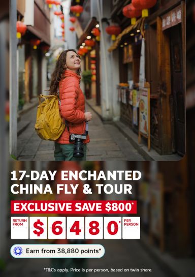 17-day enchanted China fly & tour | exclusive save $800* - return from $6480* per person | Earn from 38,880 points* | *T&Cs apply. Price is per person, based on twin share | Woman with a yellow backpack, looking at a market street in China