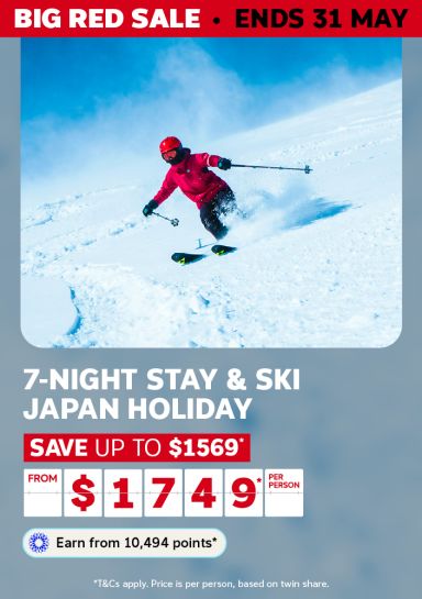 Skier carving through deep powder on a Japan mountain for a Big Red Sale 7-night Stay and Ski Japan holiday saving up to $1569 from $1749 per person