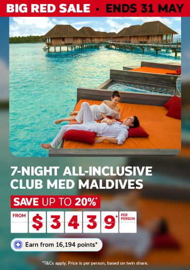 Couple relaxing on an overwater daybed in the Maldives for a 7-night all-inclusive Club Med stay saving up to 20% from $3439 per person