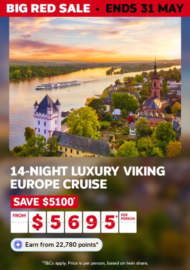 River cruise ship at golden sunset passing a turreted Rhine castle for a 14-night luxury Viking Europe cruise saving $5100 from $5695 per person