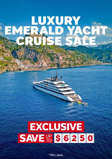 Luxury Emerald yacht cruise sale | exclusive save up to $6,250* | *T&Cs apply | Emerald cruise yacht next to a coastal town