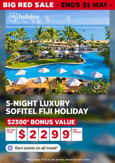 Resort pool with white umbrellas beside a calm Fiji beach for a Big Red Sale 5-night Sofitel holiday with $2300 bonus value from $2299 per person
