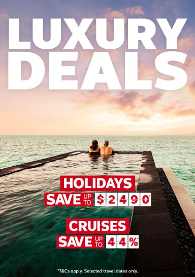 Couple relaxing in an infinity pool at sunset featuring Flight Centre Luxury Deals saving up to $2490 on holidays and 44% on cruises